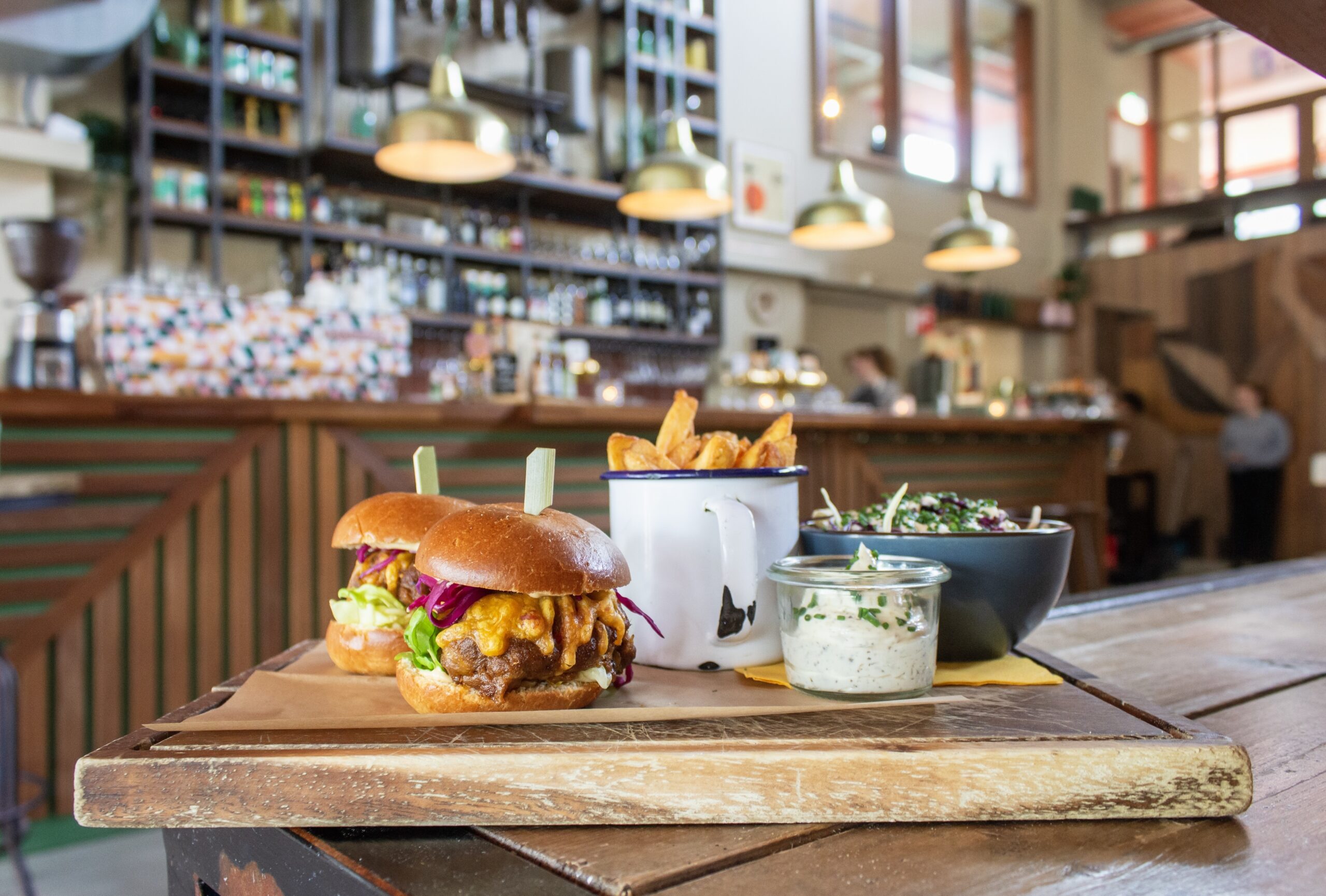 Table with a spread full of delicious food in a bar setting